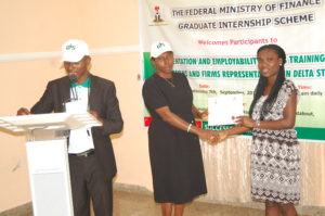 Mrs Tolu Falaiye presenting Certificate of Participation to an intern